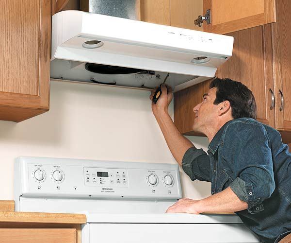 A kitchen vent hood over a stove.