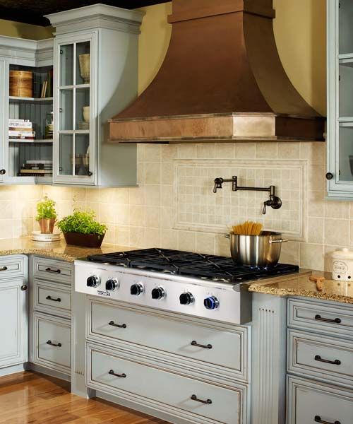 A luxe metalwork vent hood in a kitchen.
