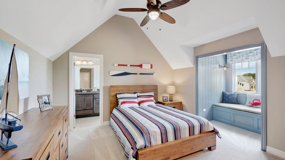 a bedroom with a ceiling fan and shades to help keep it cool